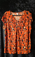 Bold Orange Abstract Print Ring-Detail Top